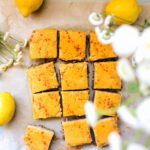 overhead shot of sliced lemon bars on parchment paper