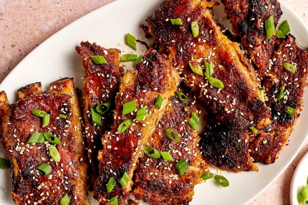 Oven baked Korean baked ribs sprinkled with green onions and sesame seeeds.