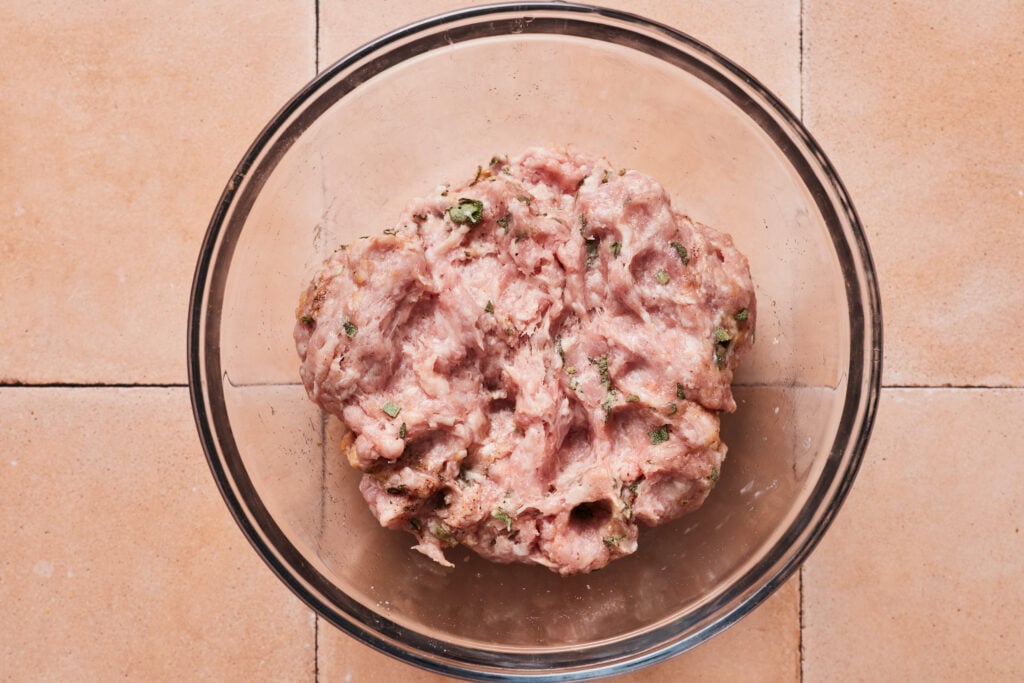 Mixing sausage mixture in a bowl