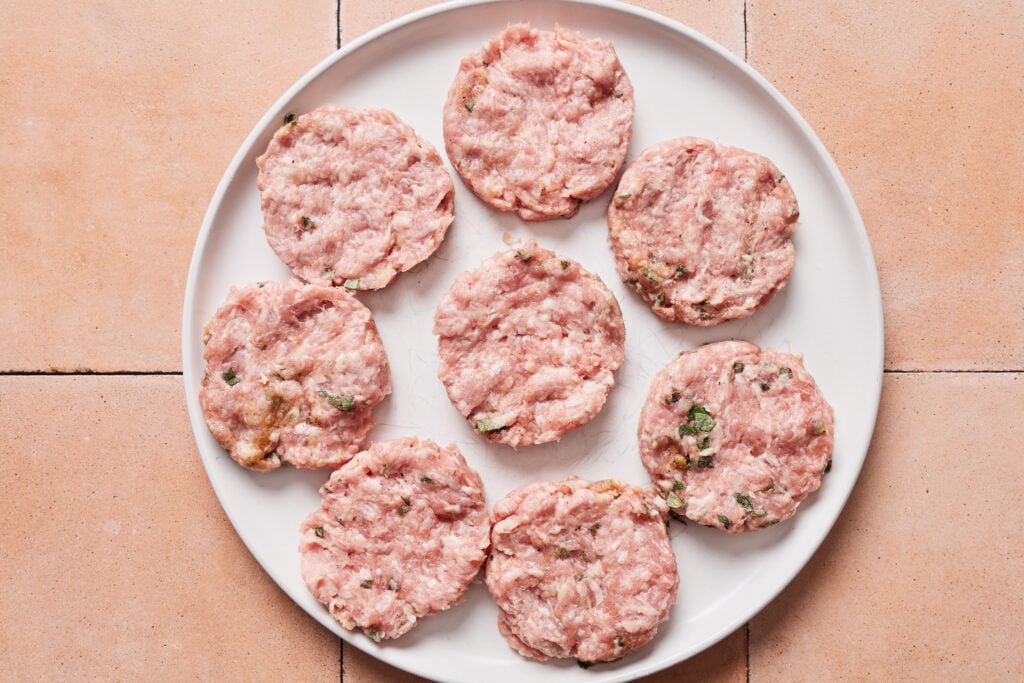Pork breakfast sausage shaped into 6 patties on a plate