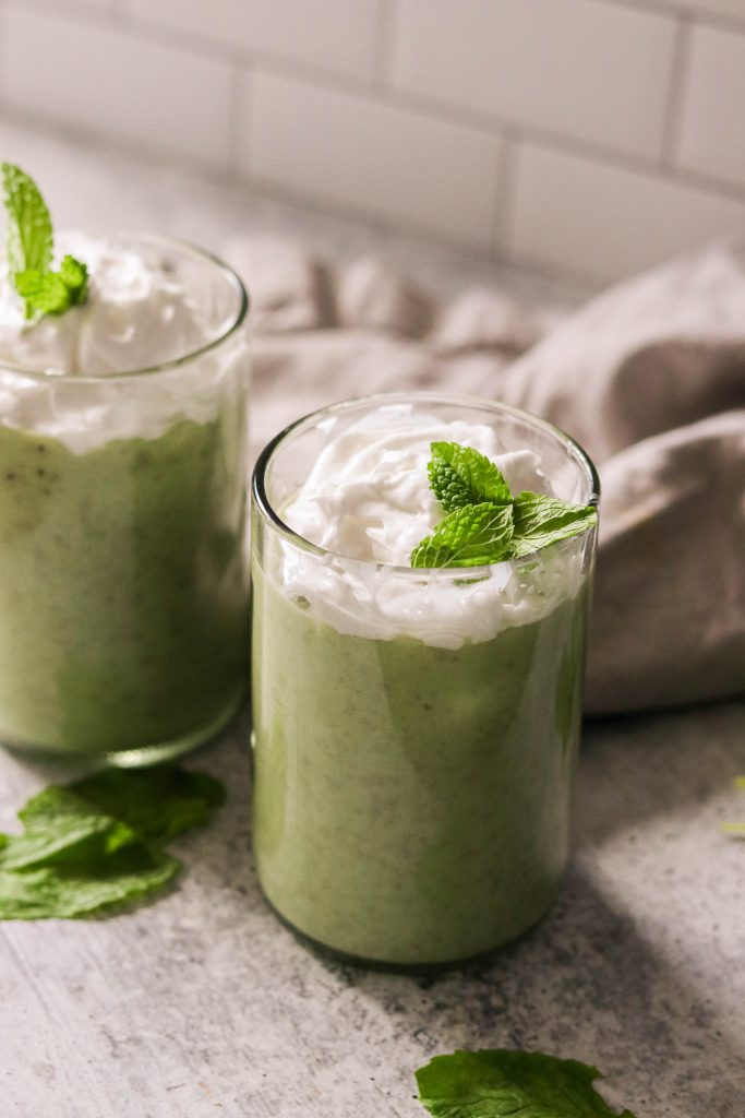 vegan shamrock shake in a glass with whipped cream