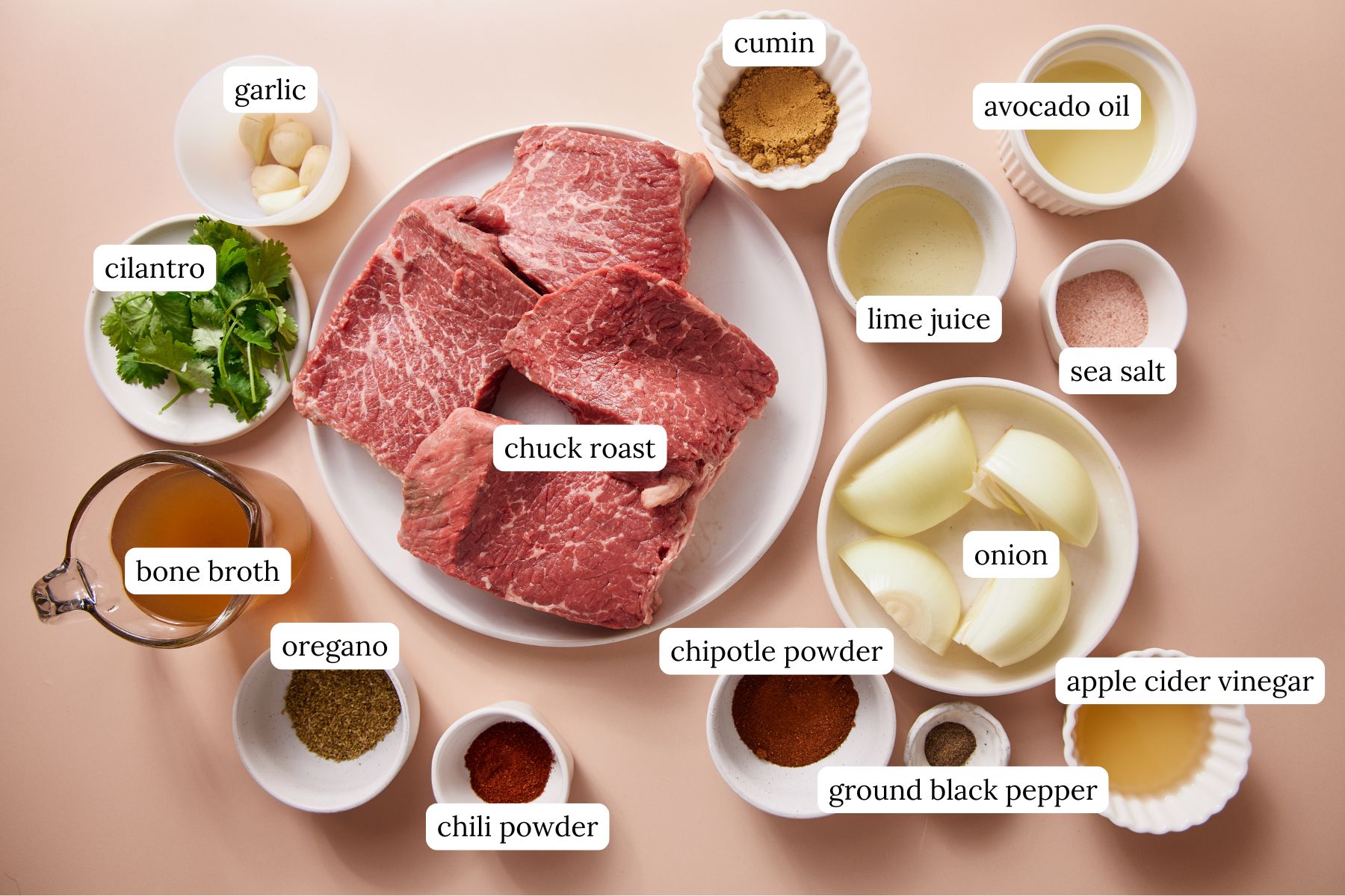 Recipe ingredients arranged in bowls on a pink countertop.
