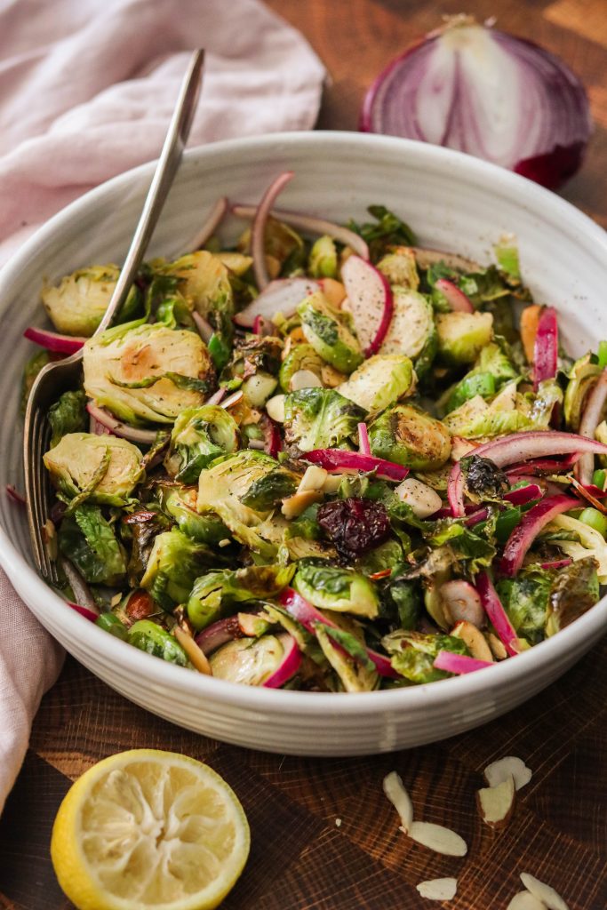 roasted brussel sprout salad served in a bowl with a fork