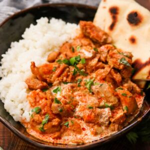 Instant Pot Butter Chicken served with rice and naan