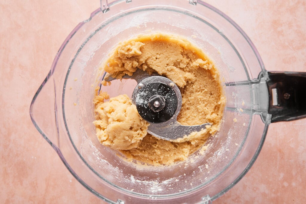 Pulsing almond flour pie crust ingredients in a food processor