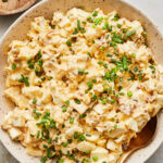 Classic egg salad served in a bowl garnished with chopped chives
