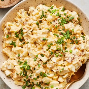 Classic egg salad served in a bowl garnished with chopped chives