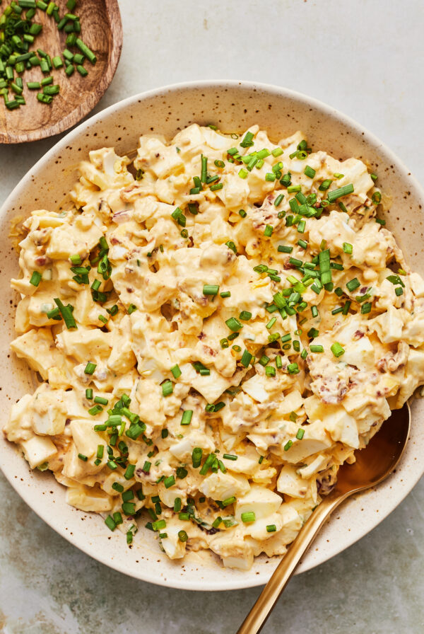 Classic egg salad served in a bowl garnished with chopped chives