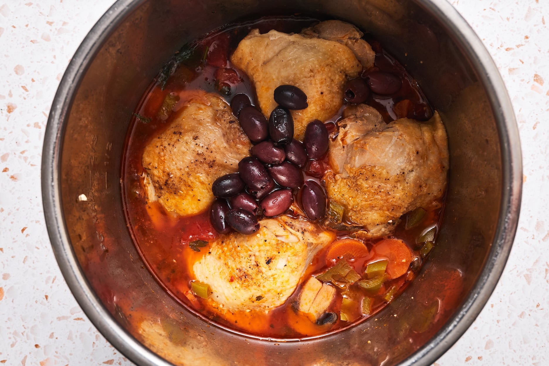 Kalamata olives added on top of cooked chicken and veggies in the Instant Pot.