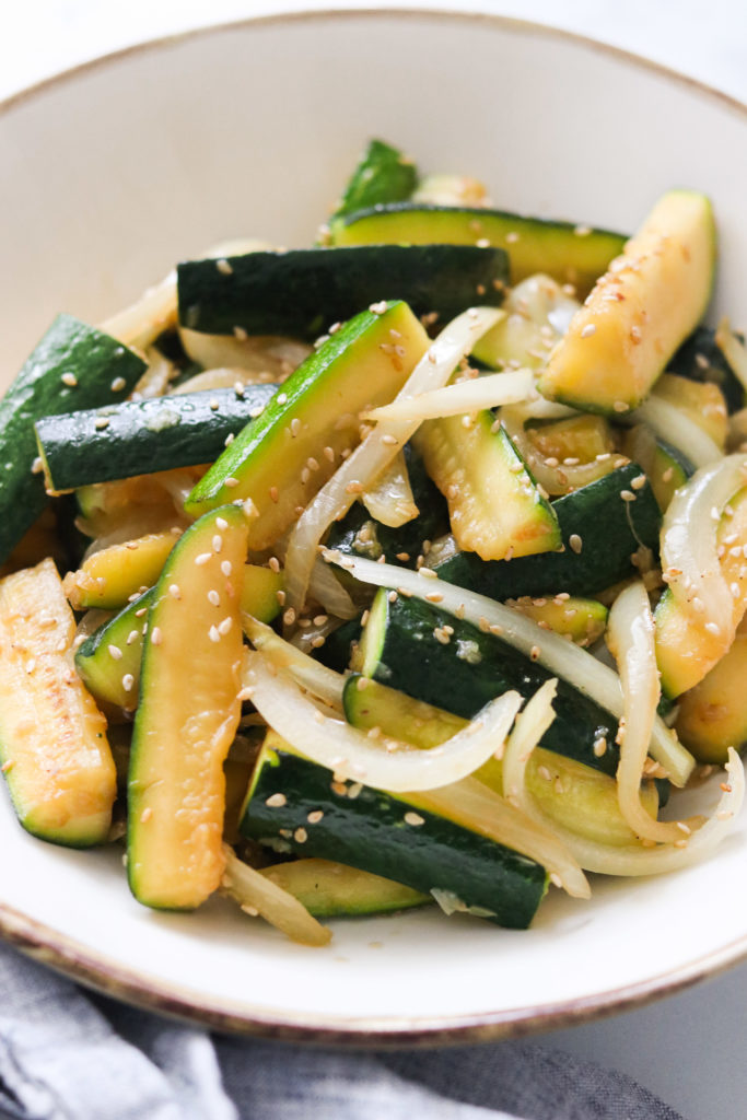Asian zucchini and onions served in a bowl