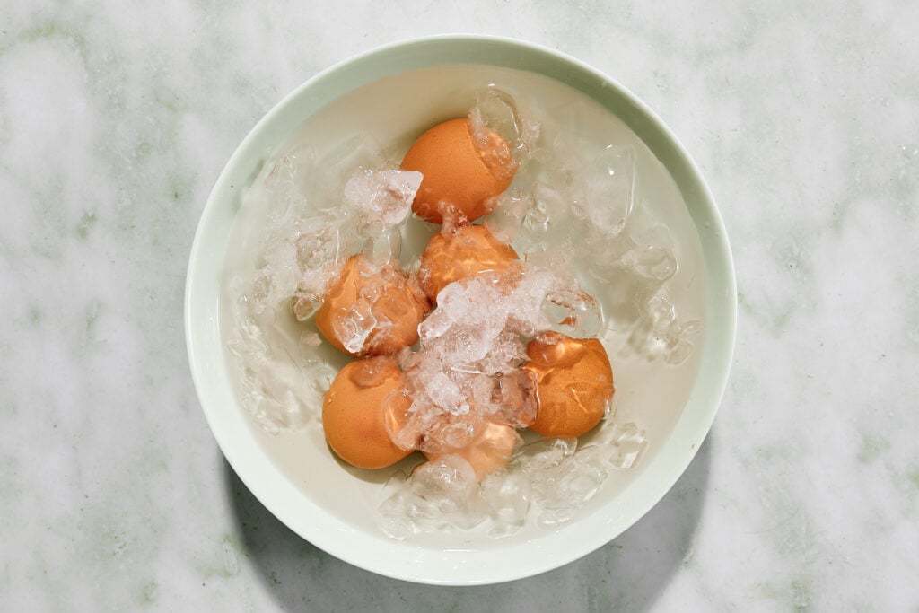 Hard boiled eggs siting in an ice bath