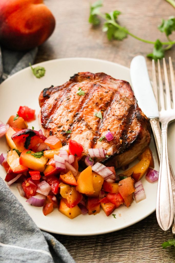 easy paleo pork chops covered with grilled peach salsa