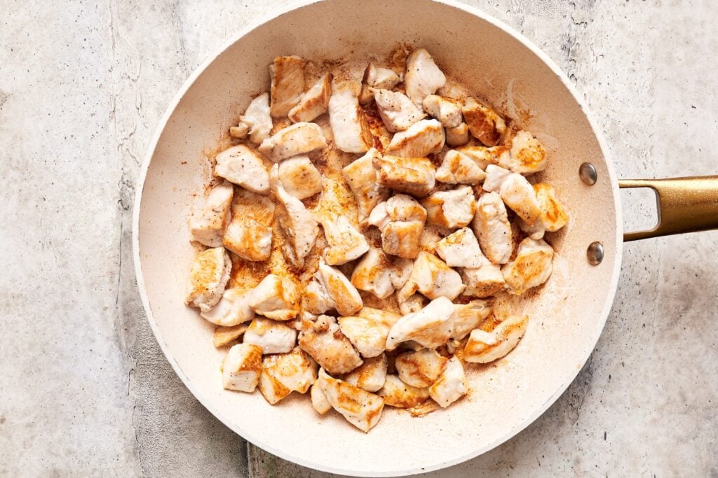 pan frying chicken in a skillet until browned