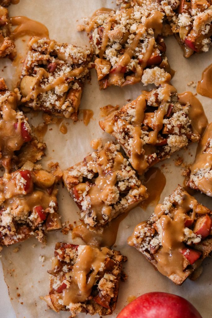 vegan apple pie bars drizzled with paleo caramel sauce cut into squares