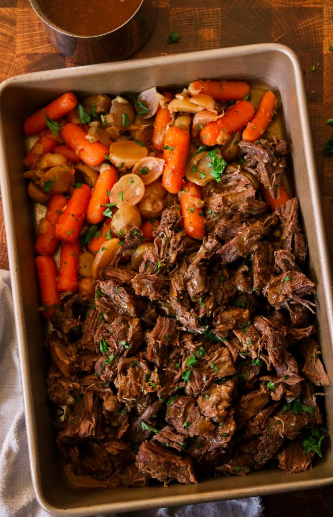 Whole30 instant pot pot roast served on a baking tray with vegetables