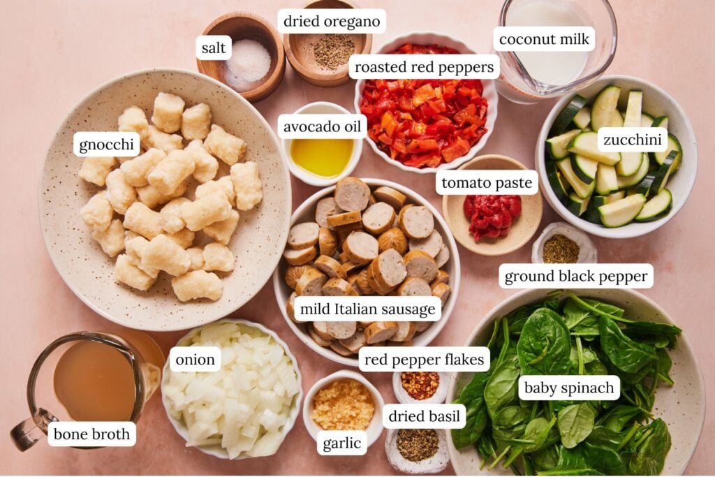 sausage and gnocchi soup ingredients in small bowls including cauliflower gnocchi, sausage, and veggies.