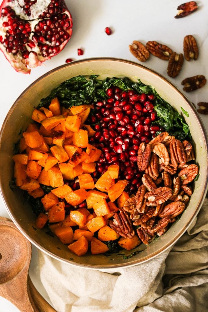 easy massaged kale salad with winter squash, pomegranate, and pecans