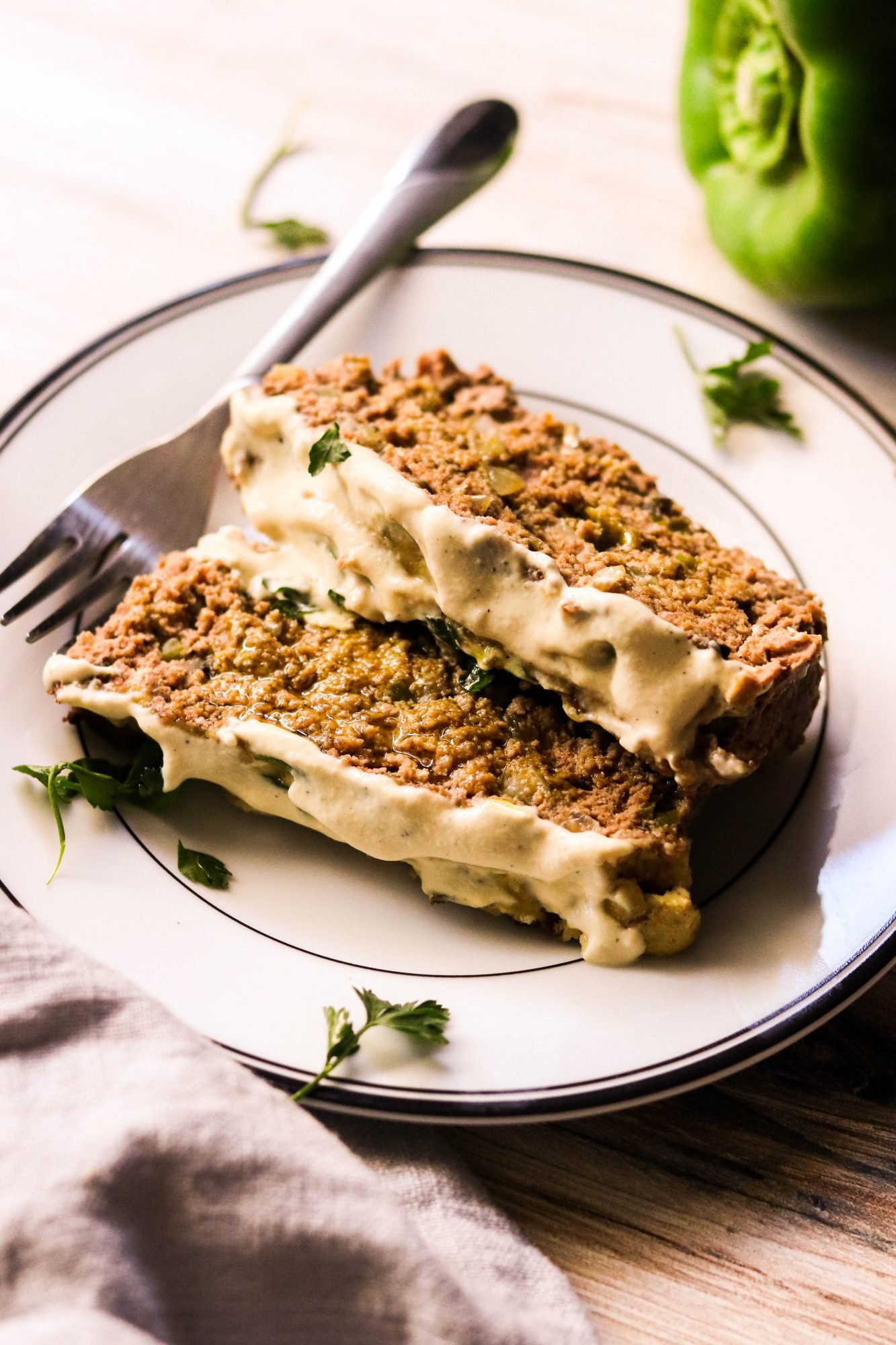 easy philly cheesesteak meatloaf recipe sliced and served on a plate