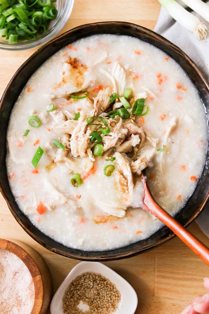 korean chicken rice porridge, garnished with green onions and sesame seeds