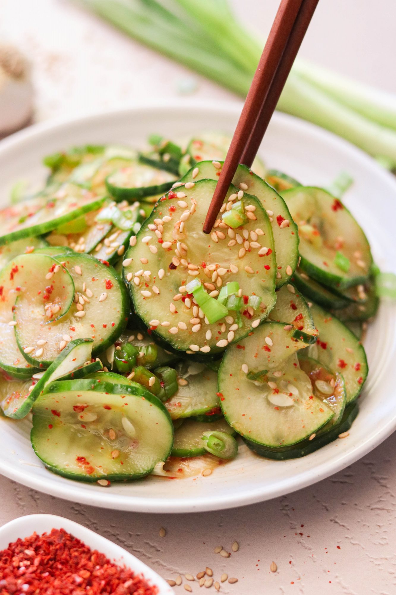 lifting up Korean cucumber salad with chopsticks