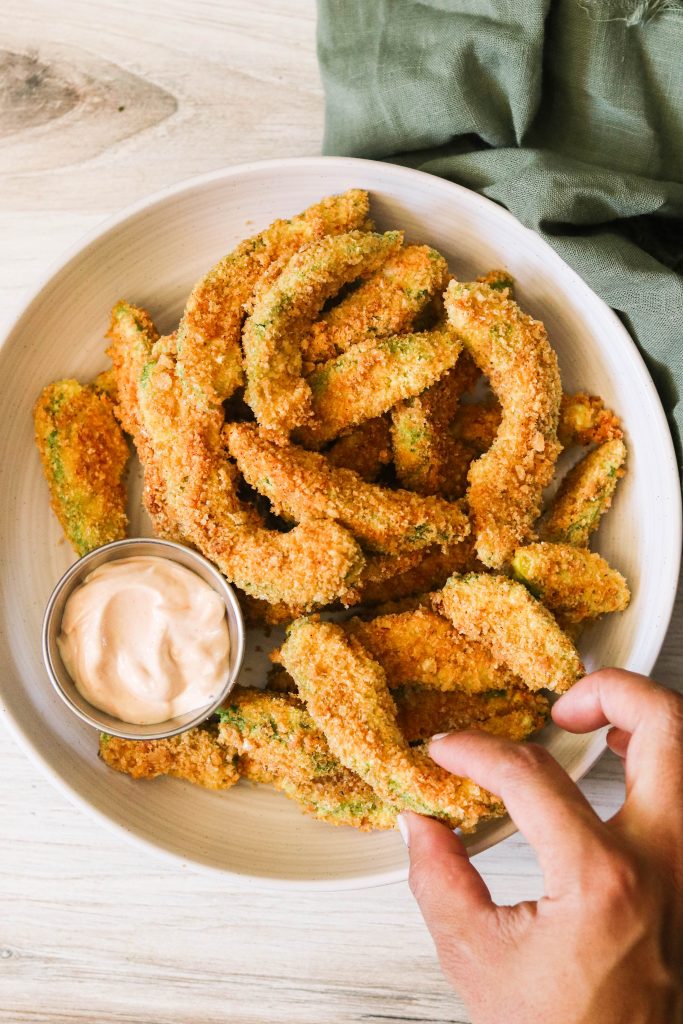 Paleo & Keto Air Fryer Avocado Fries on a plate with dipping sauce