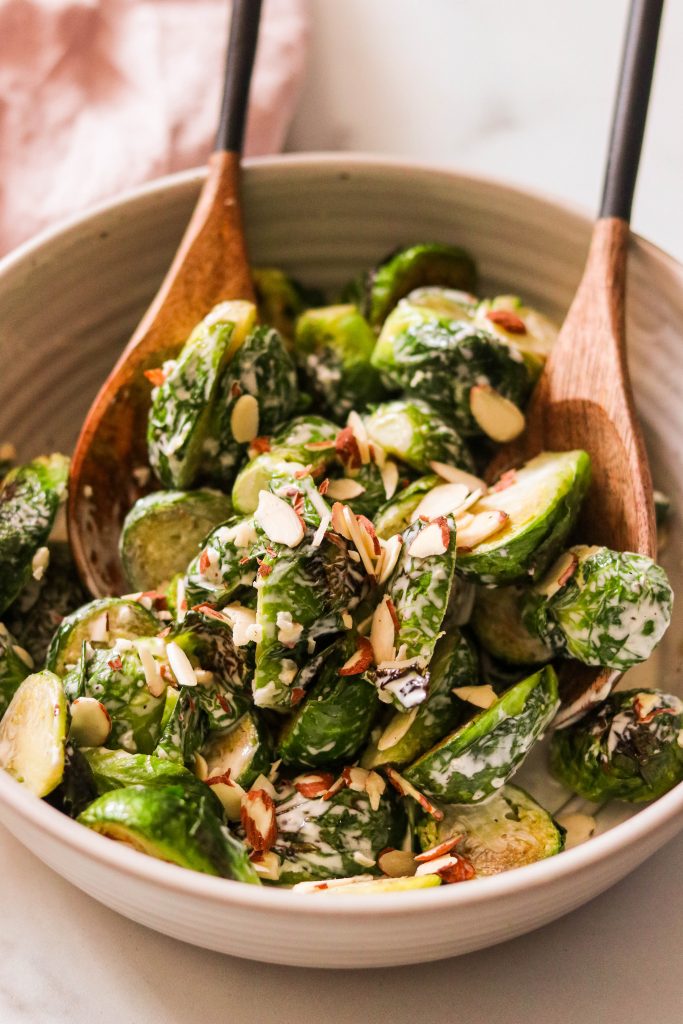 Brussels Sprout Caesar Salad topped with toasted almond slices