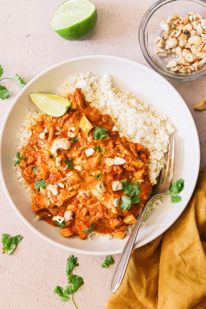 easy paleo chicken curry in a bowl with cashews and cilantro