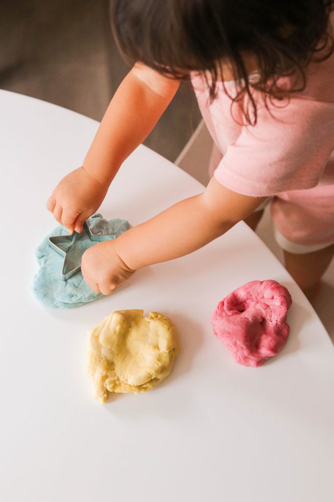 child hands on gluten free playdough