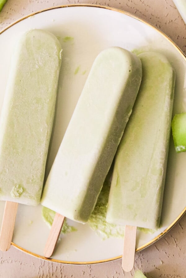 3 homemade melon bars on a white plate.