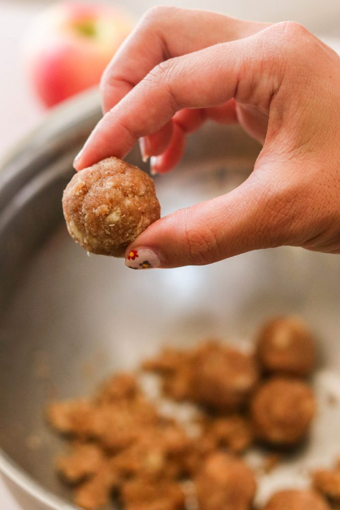 Making paleo donut holes and rolling them in a ball
