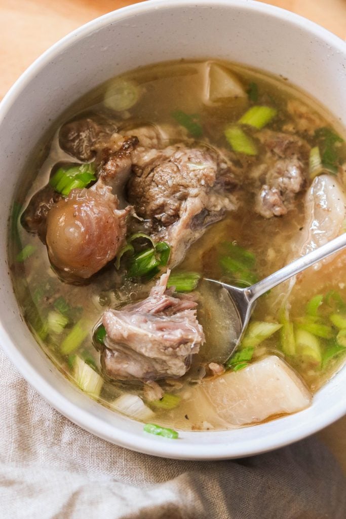 Korean oxtail soup in a bowl served with green onions