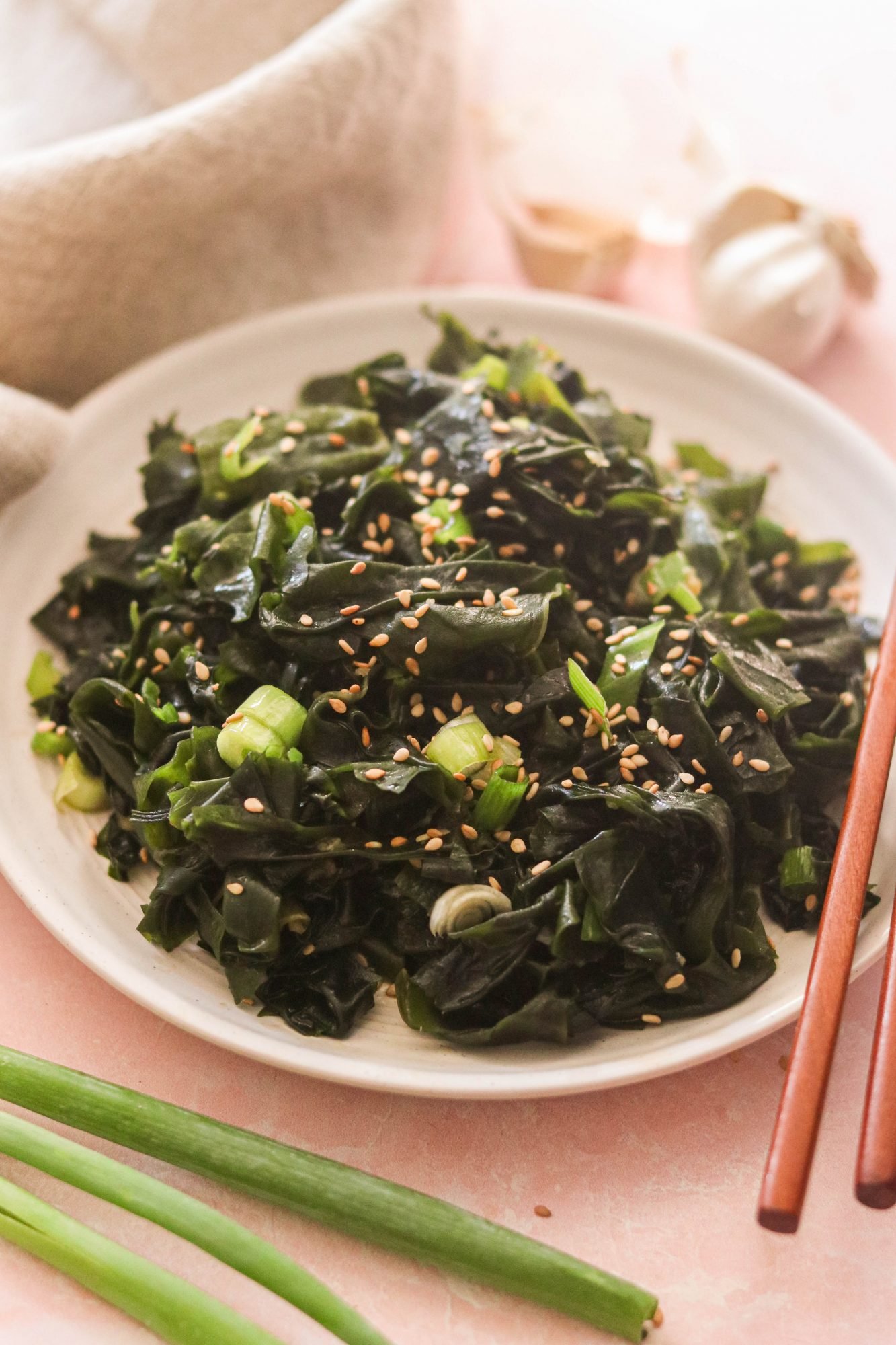 wakame seaweed salad on a plate, served with chopsticks