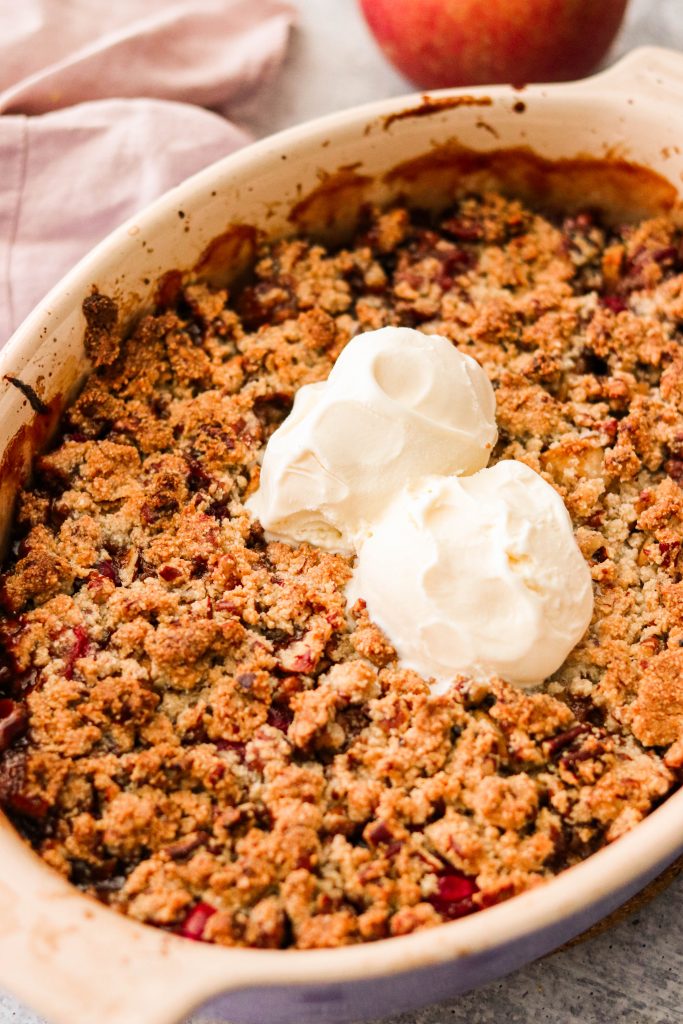 2 scoops of ice cream on freshly baked healthy apple cranberry crisp