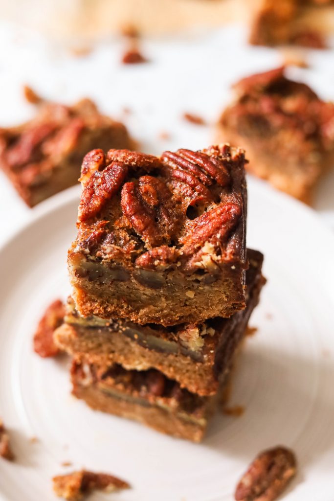 paleo pecan pie bars stacked on a plate