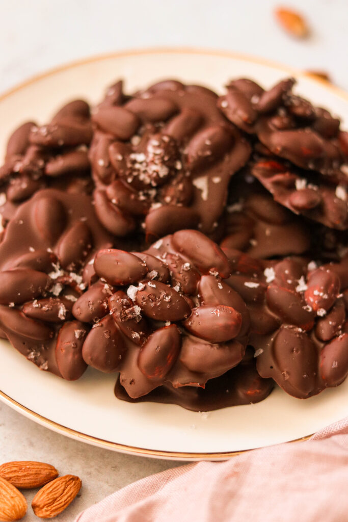 close up shot of chocolate almond clusters on a plate
