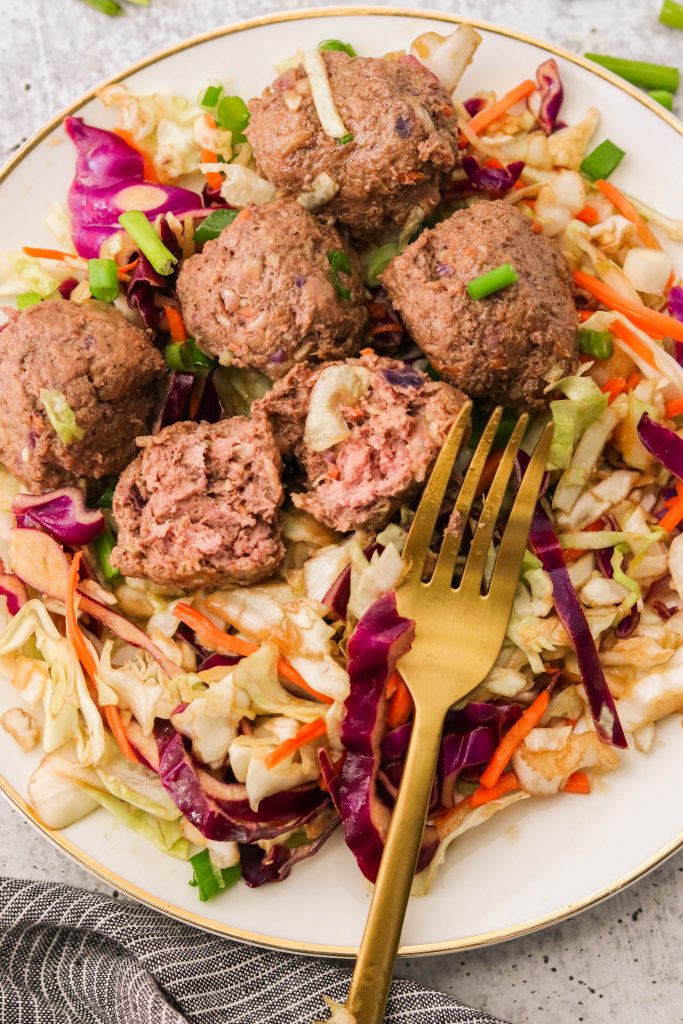 tender egg roll meatballs cut in half with a fork