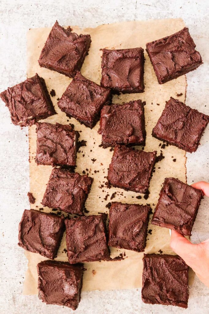 Bailey's Irish Cream brownies cut into squares on parchment paper.