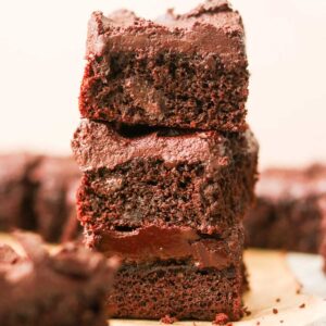 Bailey's Irish Cream Brownies stacked on parchment paper.