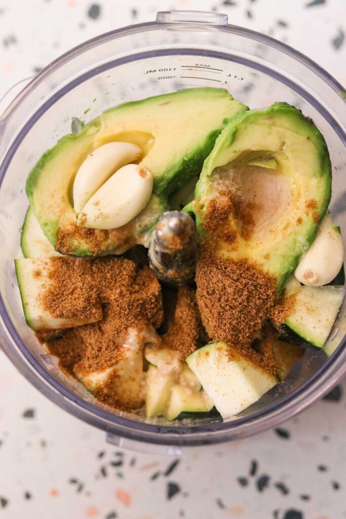 all ingredients for paleo and vegan zucchini hummus in a blender.