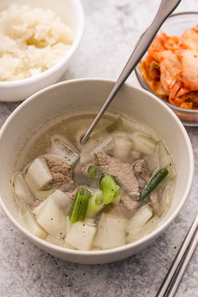 Korean beef radish soup in a bowl with a spoon