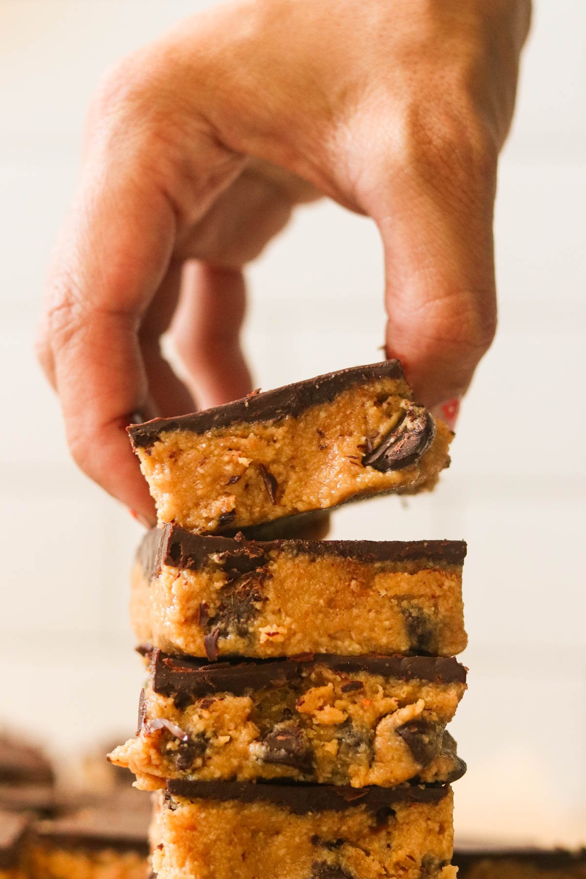 Lifting a chocolate peanut butter bar from a stack