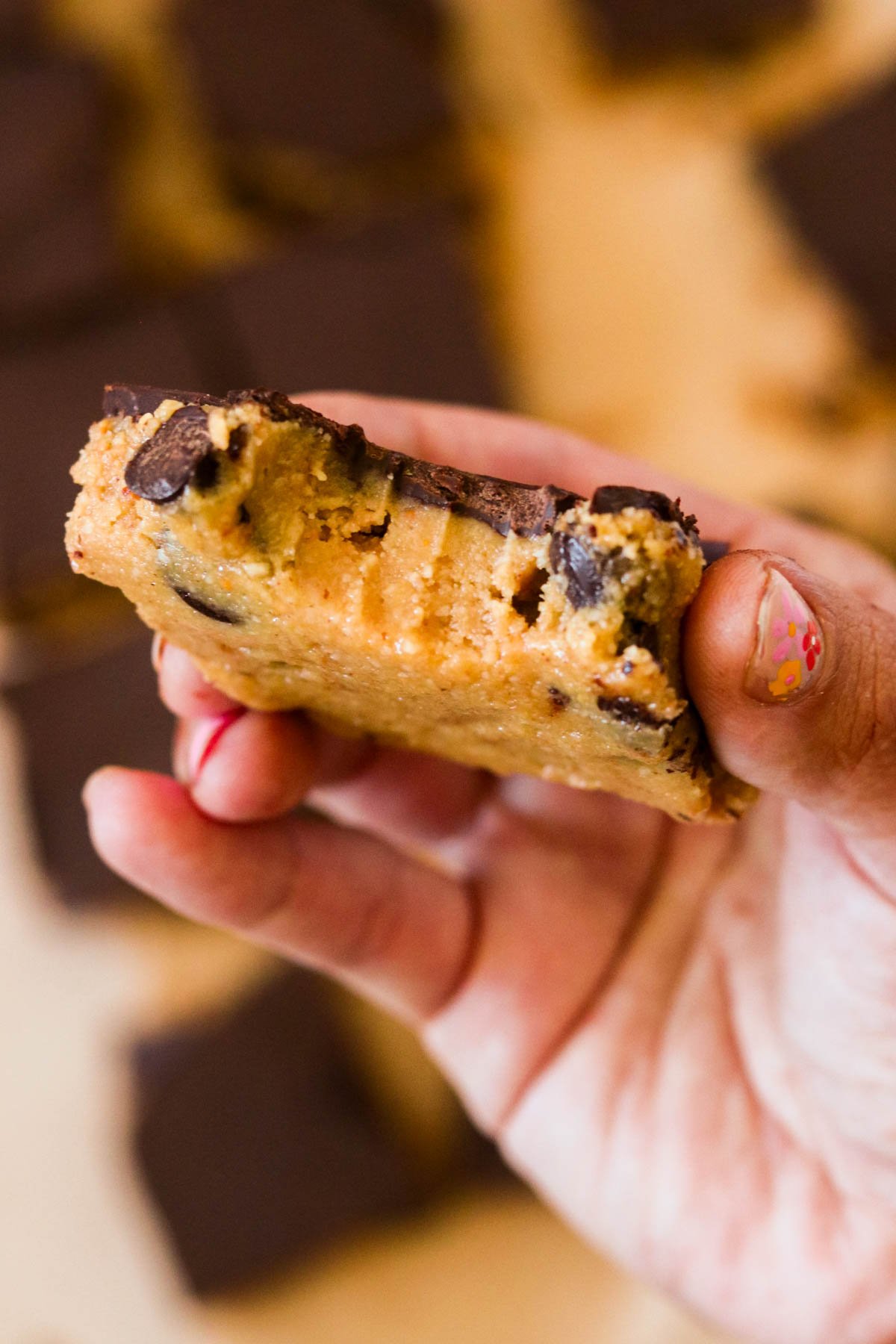 Close up view of a chocolate peanut butter bar that's been bit into.