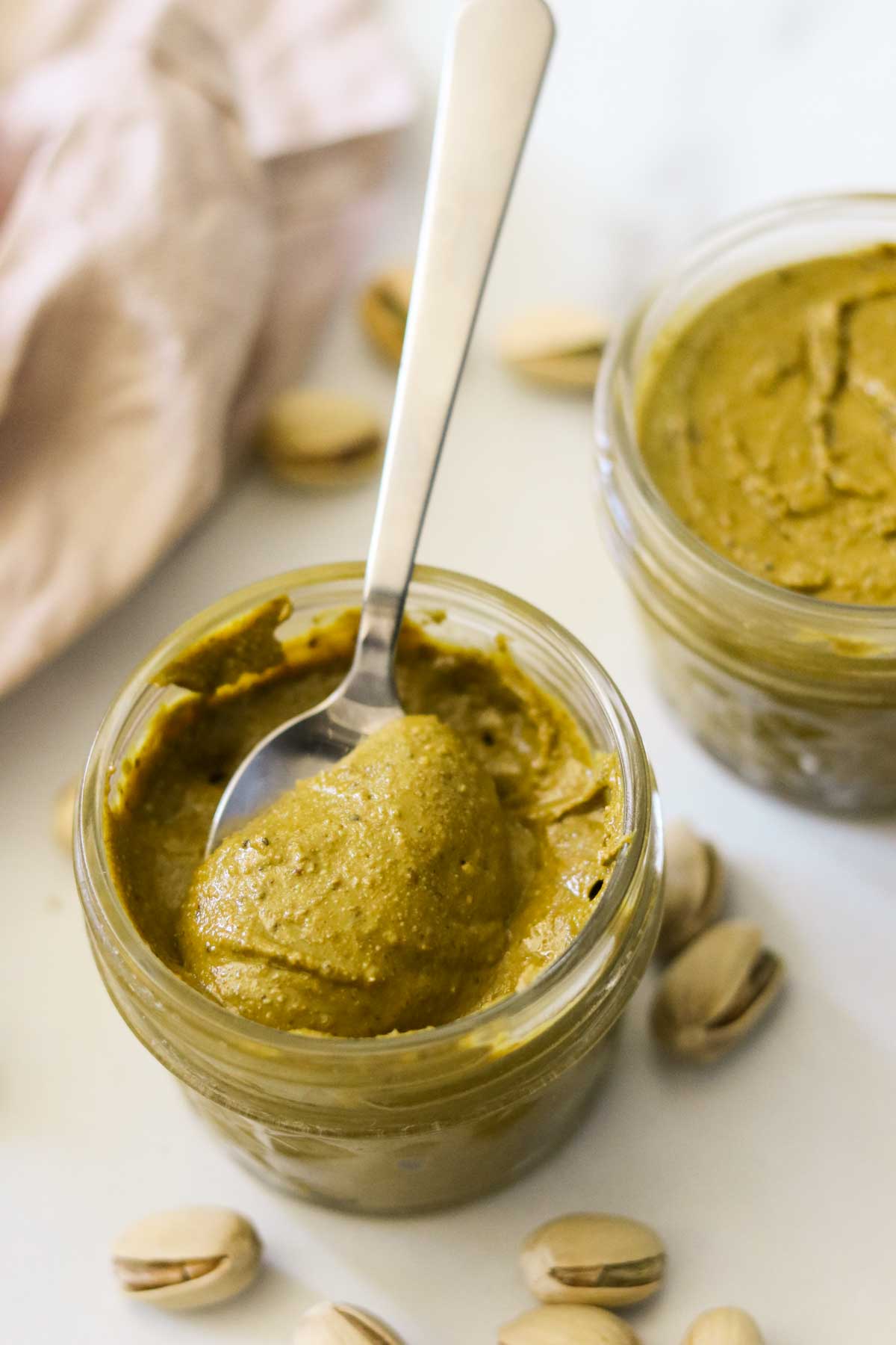 homemade pistachio butter in a jar with a spoon