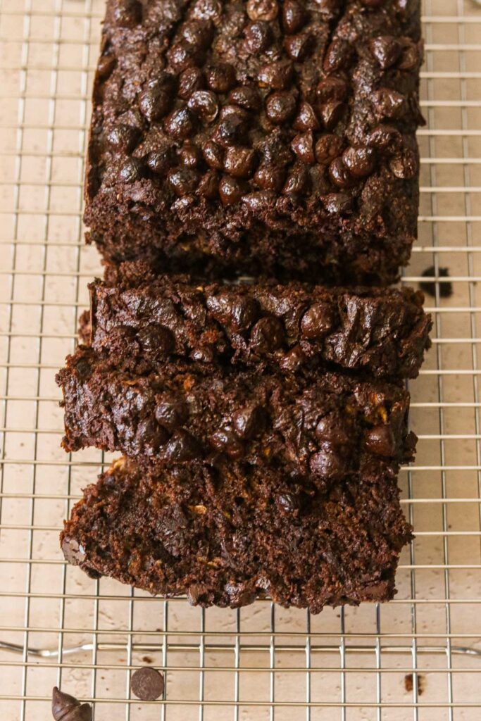 Chocolate zucchini bread on a cooling rack cut into slices