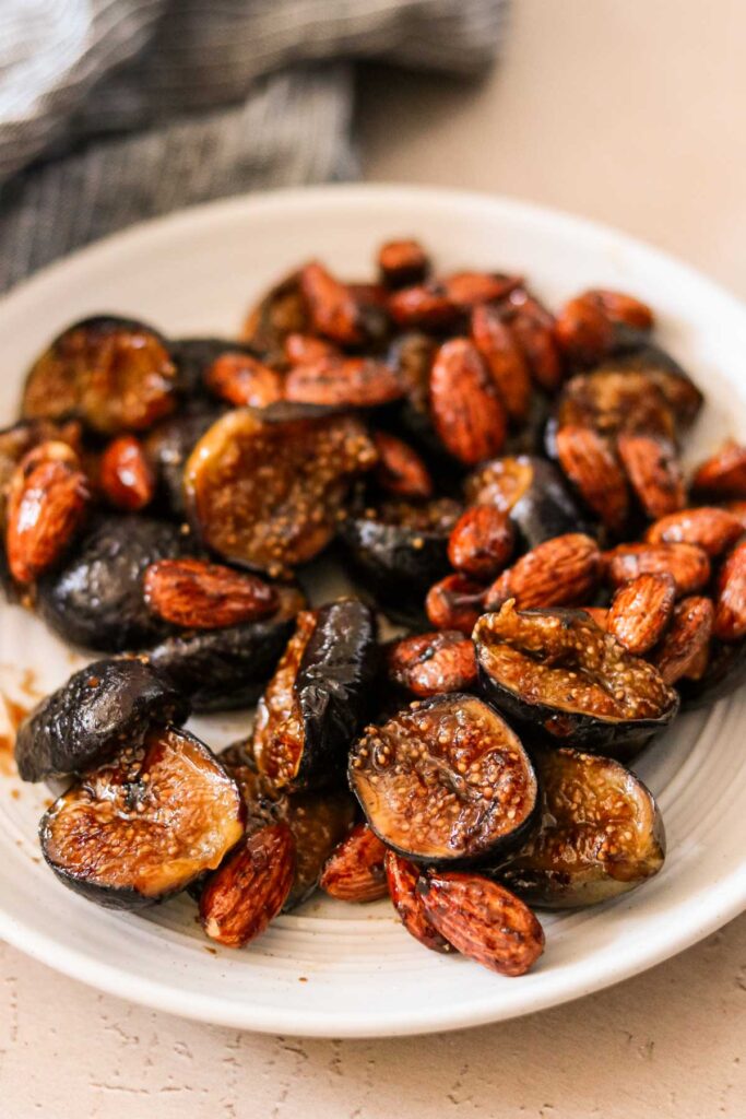 Caramelized figs on a plate with almonds