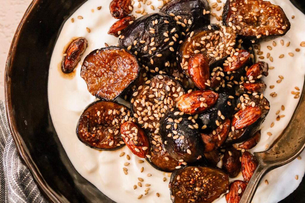Caramelized figs on top of Greek yogurt with sesame seeds and nuts