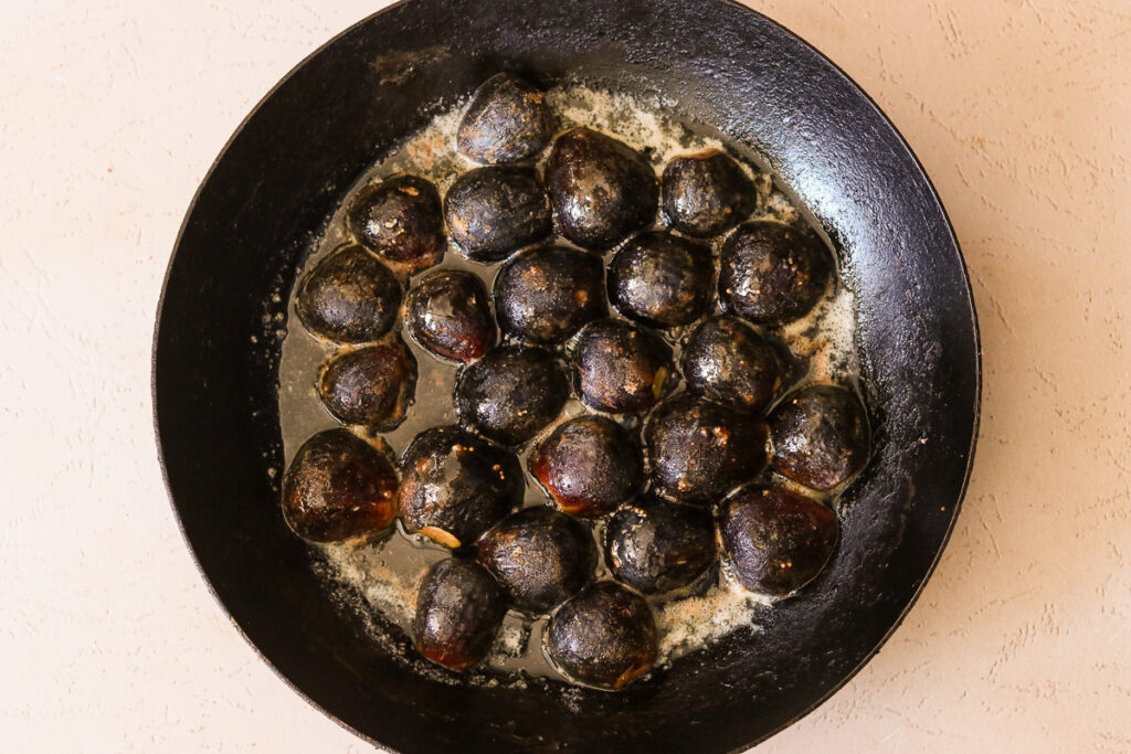 Figs cooking in butter face down until caramelized