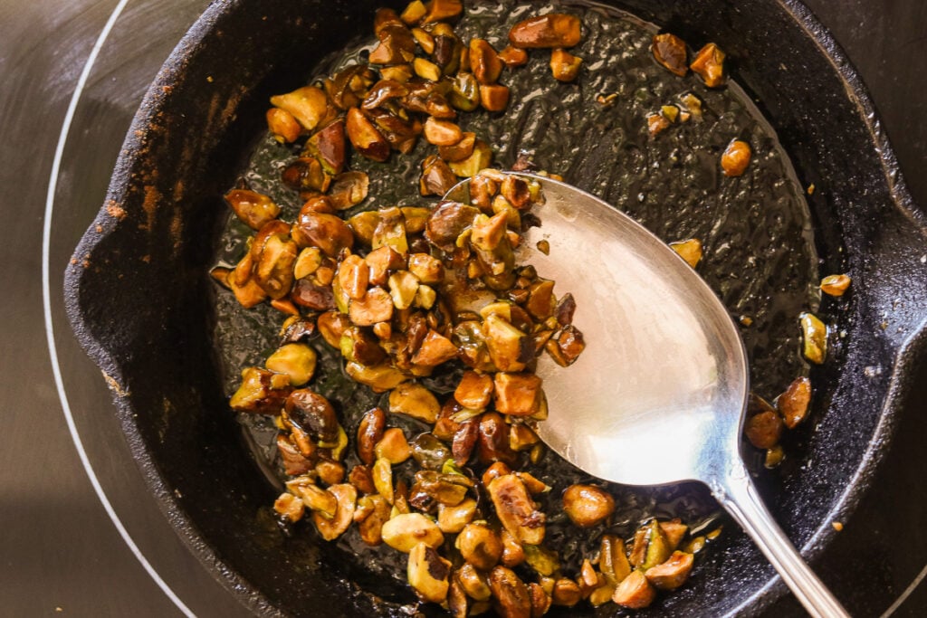 Chopped pistachios caramelized in a skillet