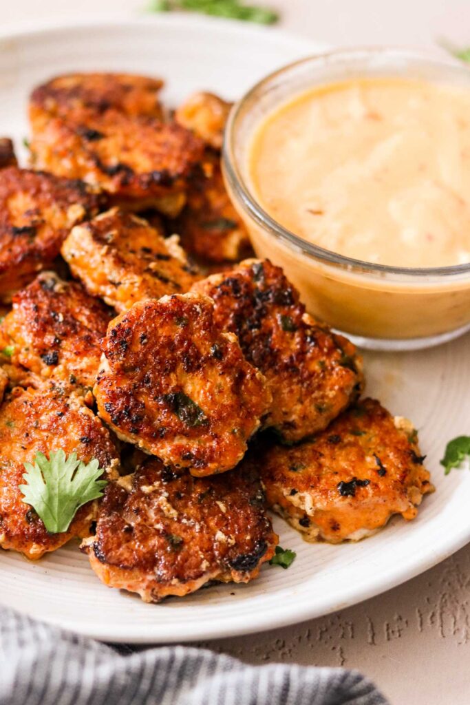 Thai shrimp cakes on a plate served with sweet chili mayo