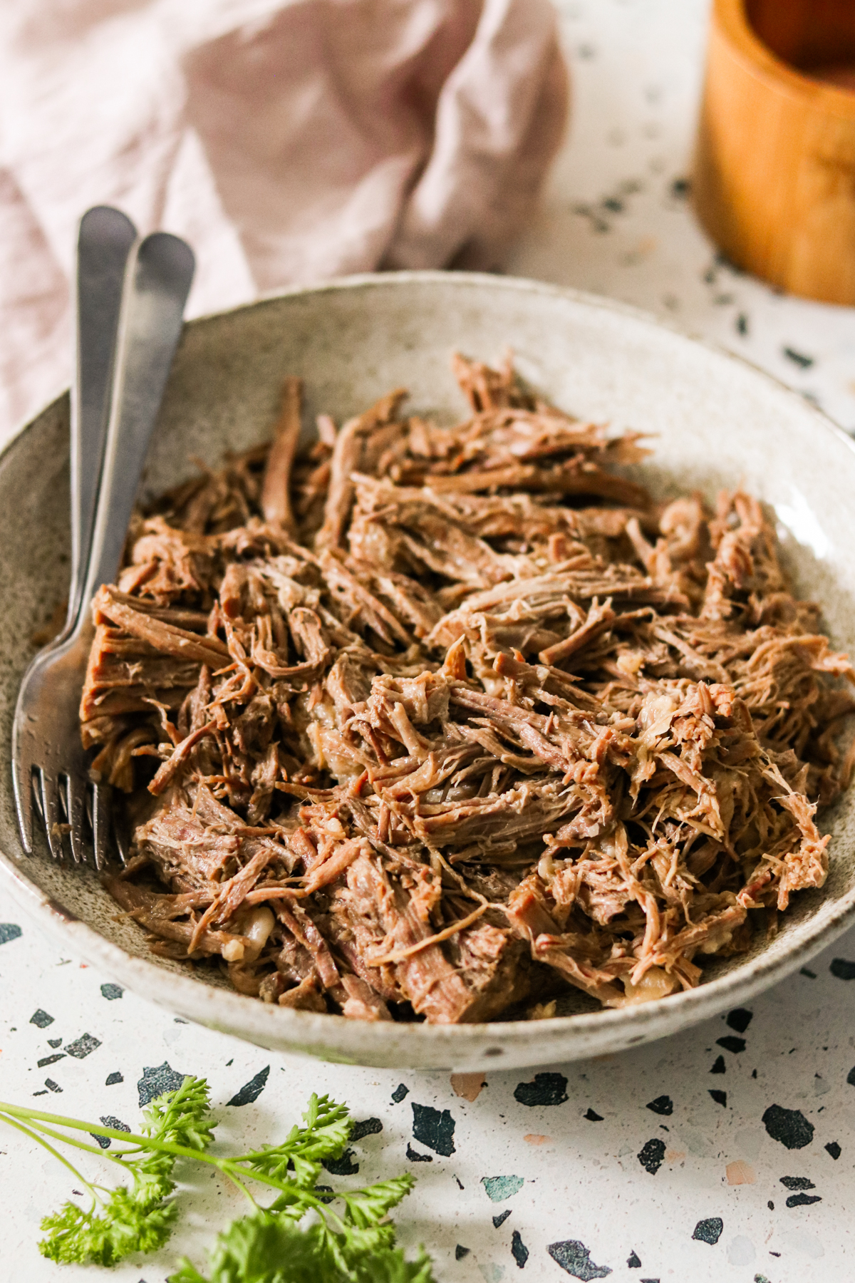 instant pot shredded beef in a bowl with a silver spoon